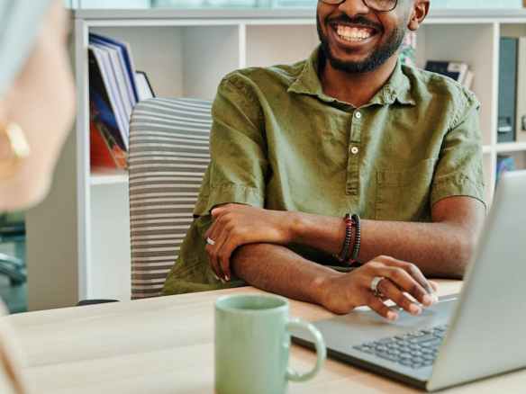 man in green polo smiling