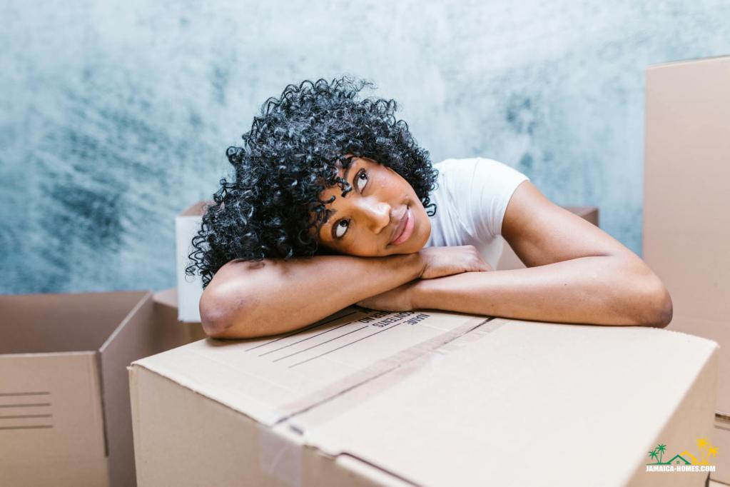 a woman resting her head on a cardboard box